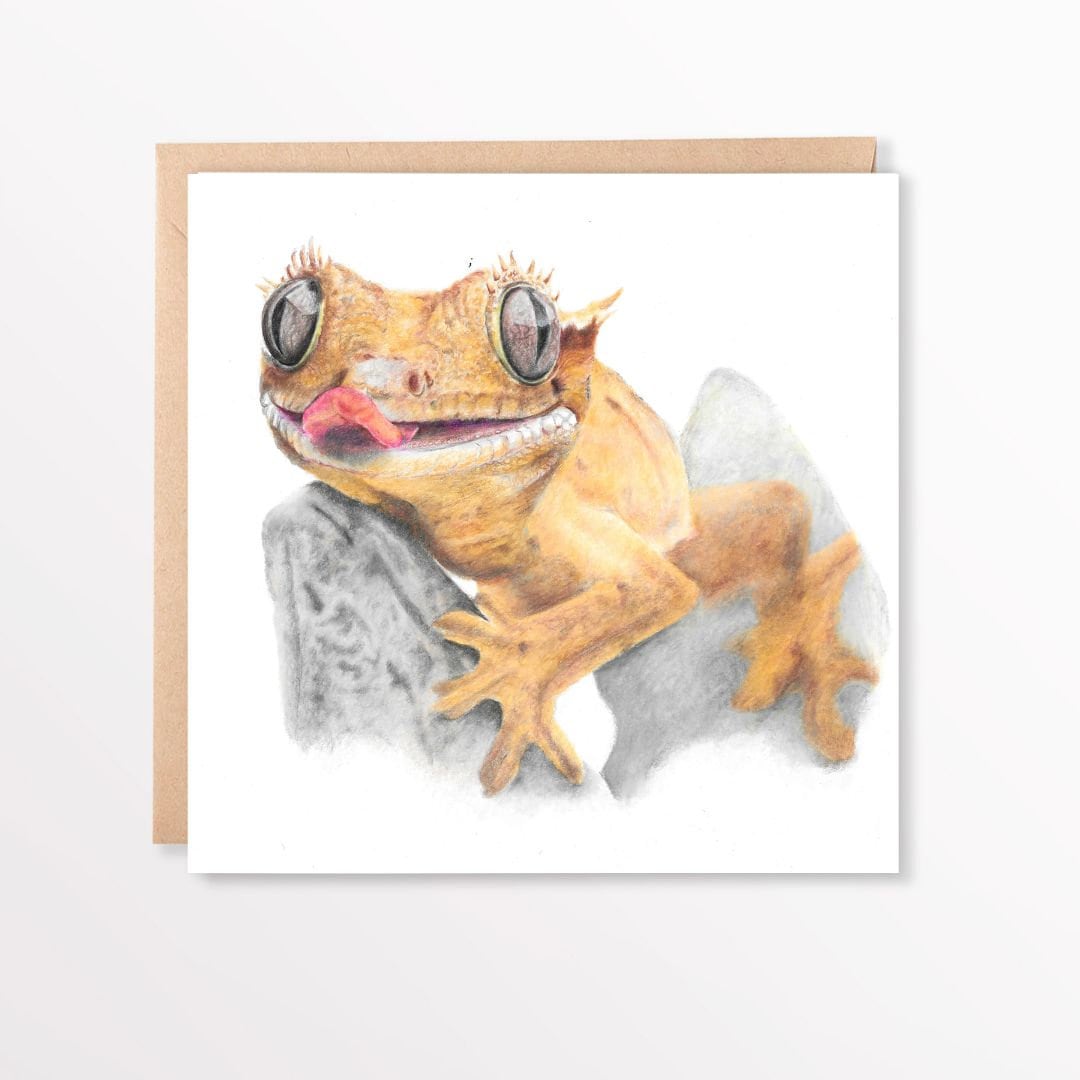 Greeting card with a hand drawn crested gecko on a rock, on a brown envelope