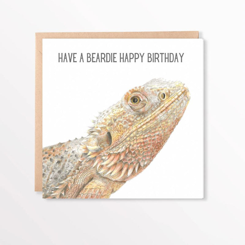 Birthday card with a bearded dragon illustration and text 'Have a beardie happy birthday' on a white background.