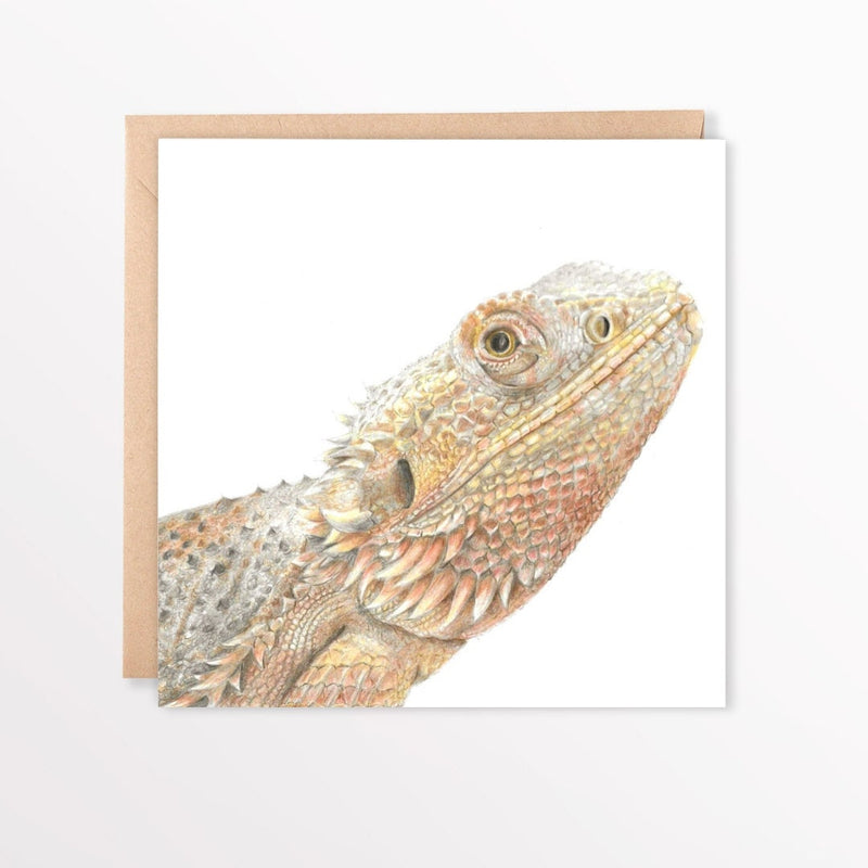 Bearded dragon illustration on a white card sat on a brown envelope